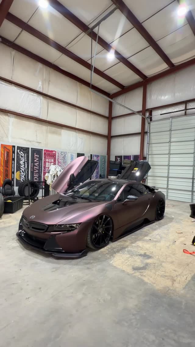 Matte bronze BMW i8 widebody on air suspension in the shop.